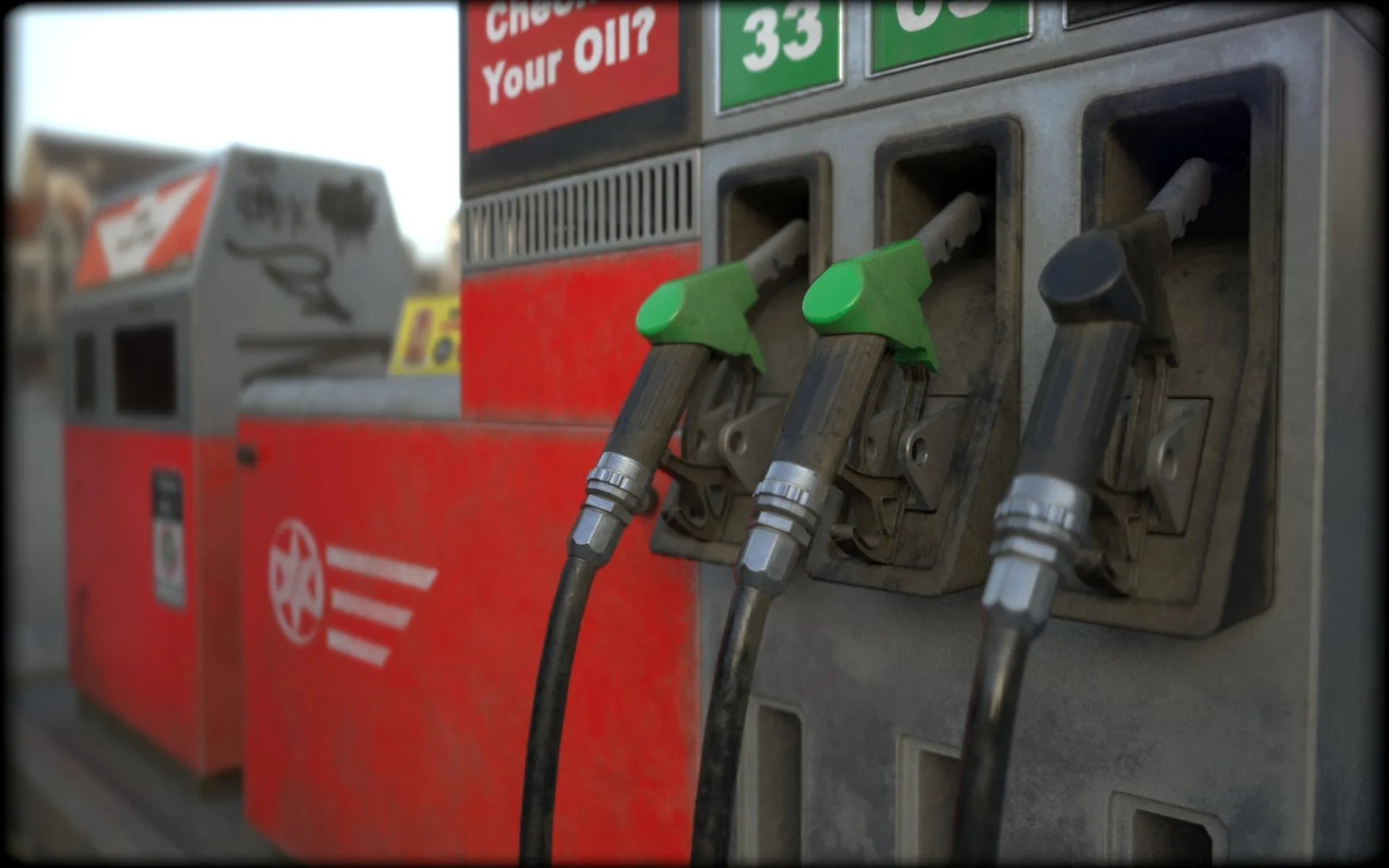 Close-up of three worn petrol pump nozzles, two green and one black, on a red and grey fuel dispenser, softly out of focus.