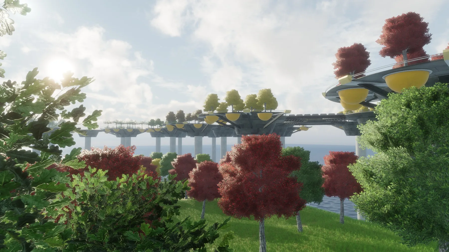 A view across the sea to walkways and round platforms on pillars, with red trees, framed by green bushes.