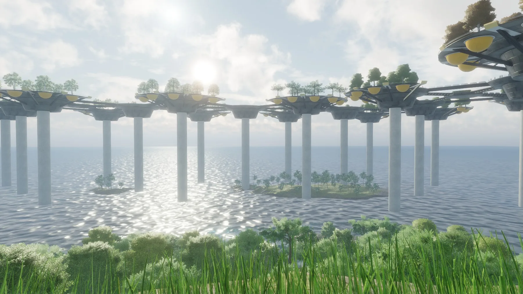 A row of pillars carrying walkways and platforms over sparkling water, seen from a grassy shore.